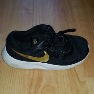 Nike Boys black and gold used sneakers